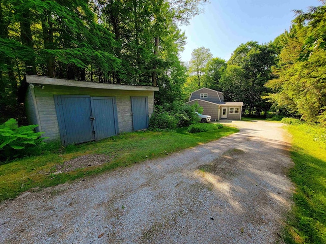 6 Cypress Ln, Essex, VT 05452 - garage with dirt driveway and a storage shed