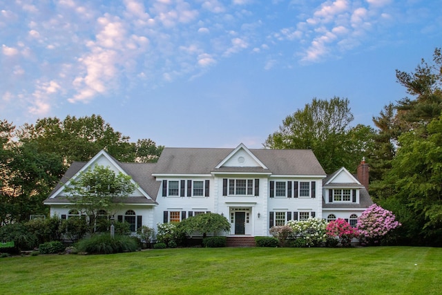 69 Exeter Rd, North Hampton, NH 03862 - view of front of house featuring a chimney and a front lawn