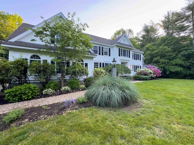 69 Exeter Rd, North Hampton, NH 03862 - view of front facade with a front lawn and roof with shingles