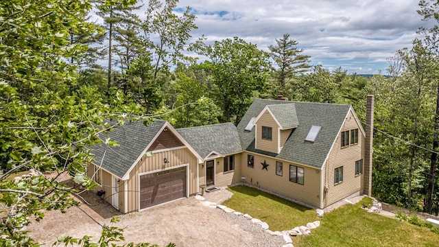 30 Thoreau Trl, Wakefield, NH 03830 - view of front facade featuring an attached garage, board and batten siding, driveway, roof with shingles, and a chimney