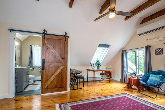 30 Thoreau Trl, Wakefield, NH 03830 - sitting room with a barn door, a wall mounted AC, baseboard heating, and wood finished floors