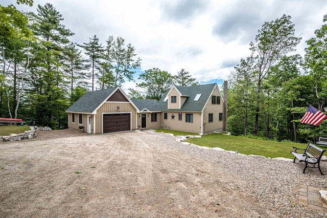 30 Thoreau Trl, Wakefield, NH 03830 - view of front of property featuring a chimney, dirt driveway, a garage, a front yard, and roof with shingles