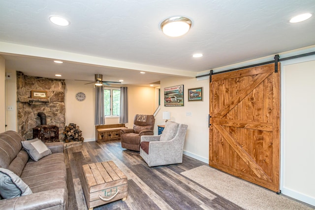 30 Thoreau Trl, Wakefield, NH 03830 - living room featuring a wood stove, a barn door, wood finished floors, recessed lighting, and ceiling fan