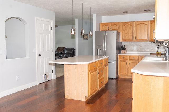 236 Cadieux Rd, Georgia, VT 05478 - kitchen with stainless steel fridge with ice dispenser, light countertops, dark wood-type flooring, tasteful backsplash, and a kitchen island