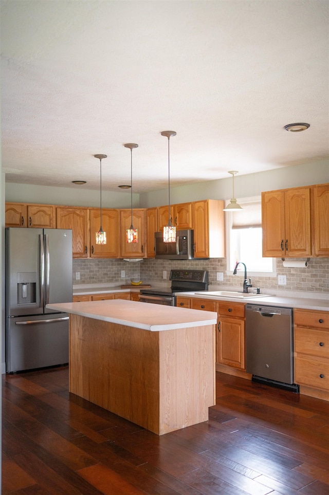 236 Cadieux Rd, Georgia, VT 05478 - kitchen featuring appliances with stainless steel finishes, light countertops, a kitchen island, tasteful backsplash, and dark wood-style flooring
