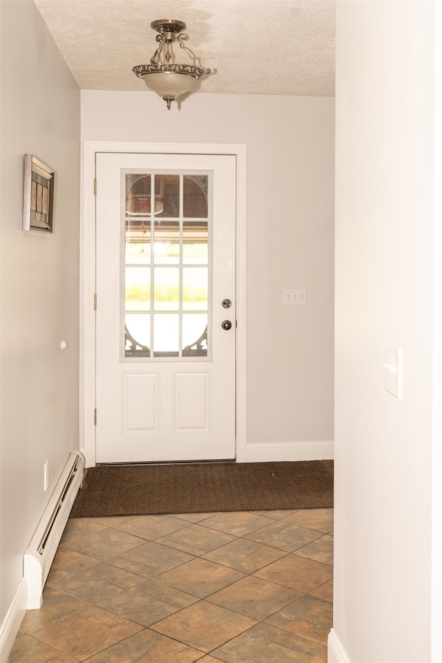 236 Cadieux Rd, Georgia, VT 05478 - doorway with a baseboard heating unit, a textured ceiling, and stone finish flooring