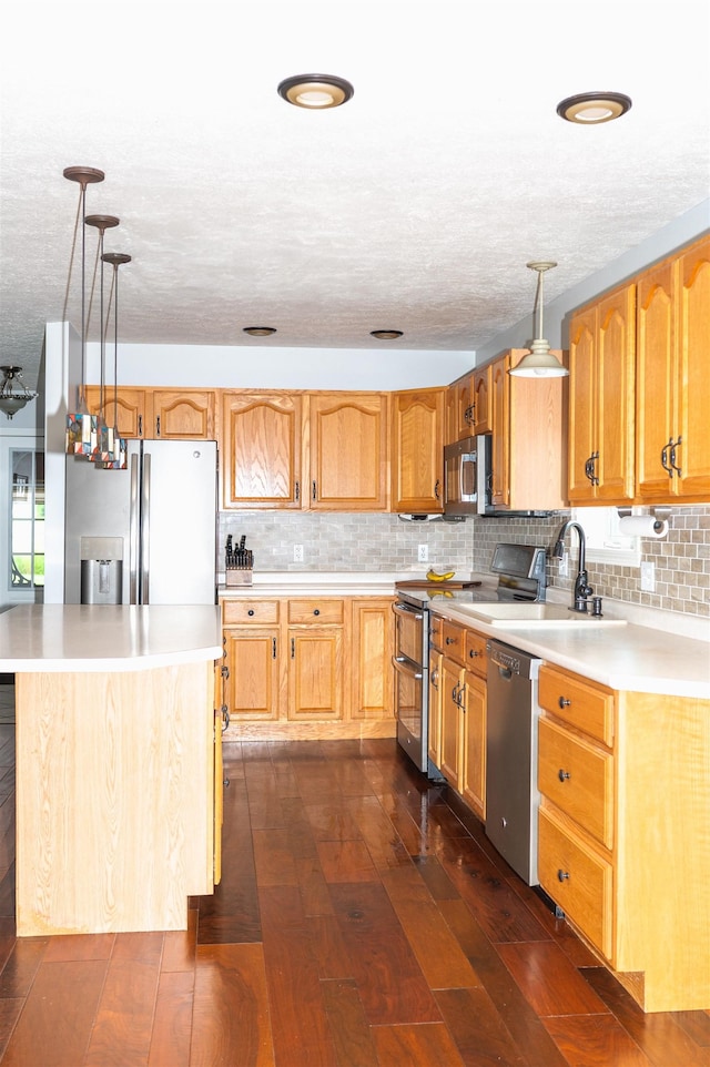 236 Cadieux Rd, Georgia, VT 05478 - kitchen featuring appliances with stainless steel finishes, a textured ceiling, hanging light fixtures, decorative backsplash, and light countertops