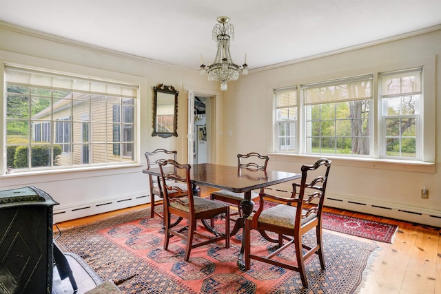 102 Hubbard Hill Rd, Rindge, NH 03461 - dining area featuring a baseboard radiator, healthy amount of natural light, a chandelier, hardwood / wood-style floors, and ornamental molding