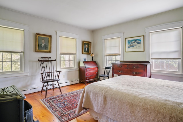 102 Hubbard Hill Rd, Rindge, NH 03461 - bedroom with multiple windows, hardwood / wood-style floors, a baseboard radiator, and ornamental molding