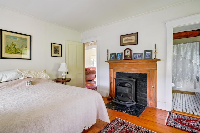 102 Hubbard Hill Rd, Rindge, NH 03461 - bedroom with hardwood / wood-style flooring, ornamental molding, and a fireplace with flush hearth