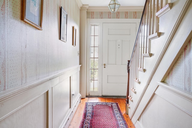 102 Hubbard Hill Rd, Rindge, NH 03461 - doorway to outside with wallpapered walls, light wood finished floors, stairs, ornamental molding, and a wainscoted wall