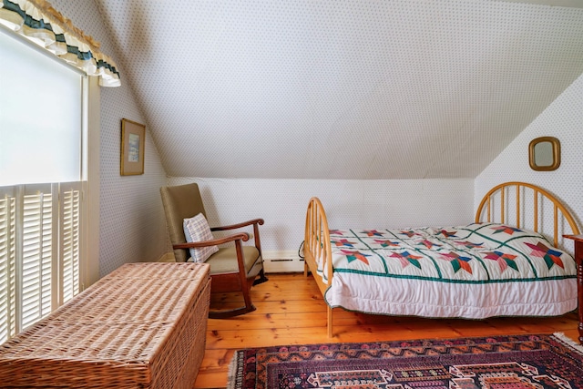 102 Hubbard Hill Rd, Rindge, NH 03461 - bedroom with wallpapered walls, hardwood / wood-style floors, vaulted ceiling, and a baseboard heating unit