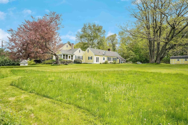 102 Hubbard Hill Rd, Rindge, NH 03461 - view of front of house featuring a storage shed, a chimney, and a front yard