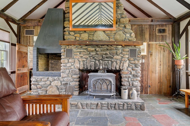 102 Hubbard Hill Rd, Rindge, NH 03461 - unfurnished living room with stone tile floors, a wood stove, and wooden walls