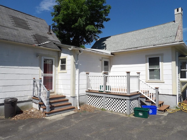 25 Downing St, Concord, NH 03301 - entrance to property featuring a shingled roof and a chimney