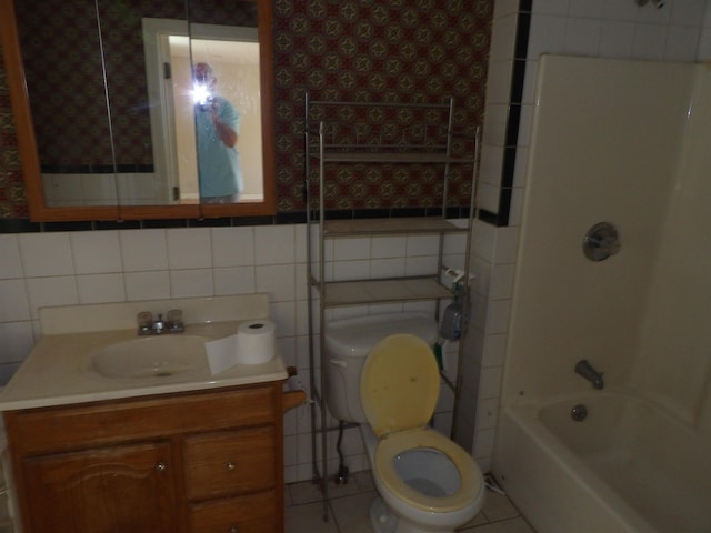 25 Downing St, Concord, NH 03301 - full bathroom featuring wallpapered walls, vanity, tile walls, tile patterned floors, and bathtub / shower combination