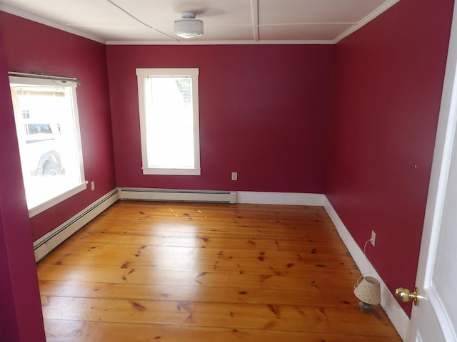25 Downing St, Concord, NH 03301 - spare room with ornamental molding, a baseboard radiator, and light wood finished floors