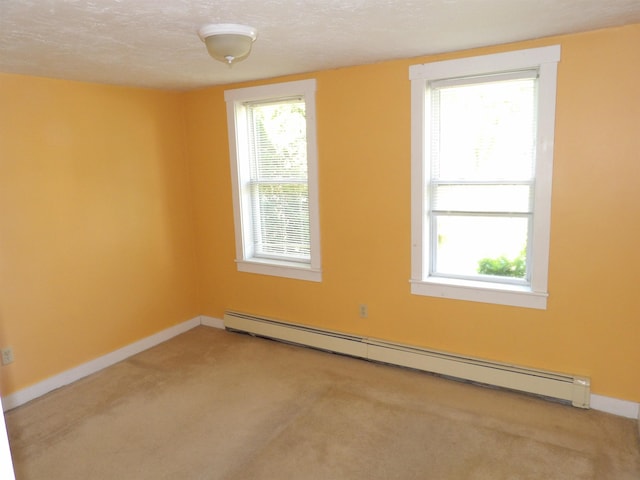 25 Downing St, Concord, NH 03301 - carpeted spare room featuring a baseboard heating unit and baseboards