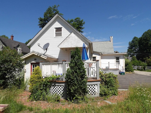 25 Downing St, Concord, NH 03301 - view of front facade featuring a deck and a chimney