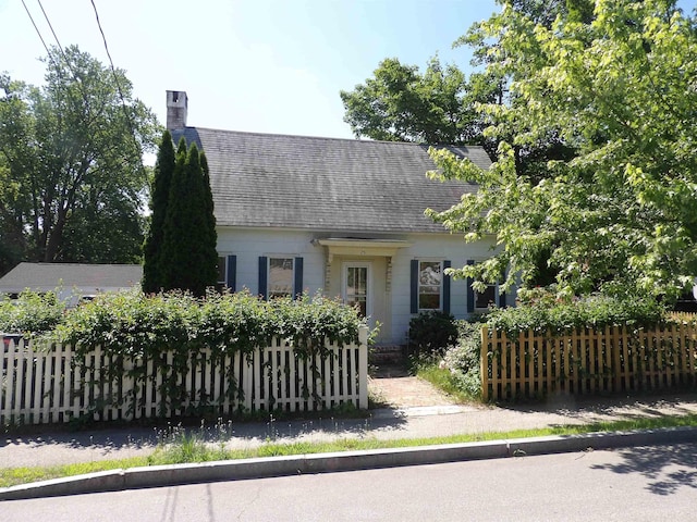 25 Downing St, Concord, NH 03301 - cape cod-style house with a chimney and a shingled roof