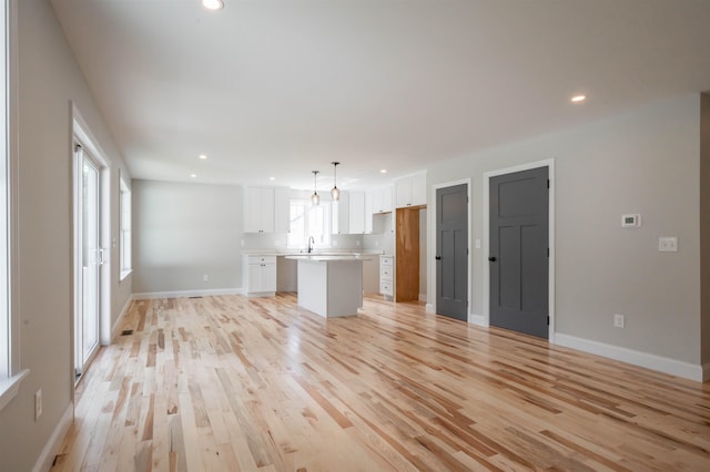 72-1 N Mast St, Goffstown, NH 03045 - unfurnished living room with light wood-style flooring and recessed lighting