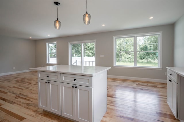 72-1 N Mast St, Goffstown, NH 03045 - kitchen with light wood-style floors, decorative light fixtures, white cabinetry, a center island, and recessed lighting