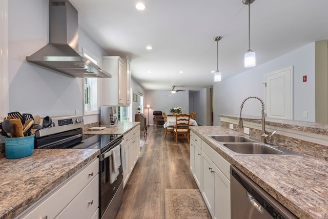 23 Pork Hill Rd, Ossipee, NH 03864 - kitchen featuring appliances with stainless steel finishes, wall chimney range hood, white cabinetry, pendant lighting, and recessed lighting
