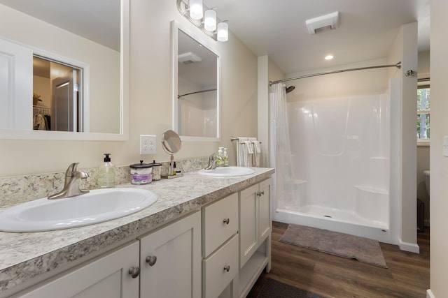 23 Pork Hill Rd, Ossipee, NH 03864 - bathroom with wood finished floors, double vanity, a shower with curtain, recessed lighting, and a spacious closet