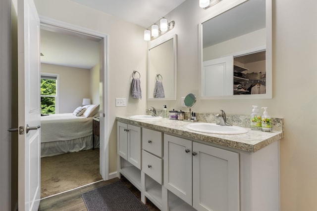 23 Pork Hill Rd, Ossipee, NH 03864 - ensuite bathroom with double vanity, wood finished floors, and a spacious closet