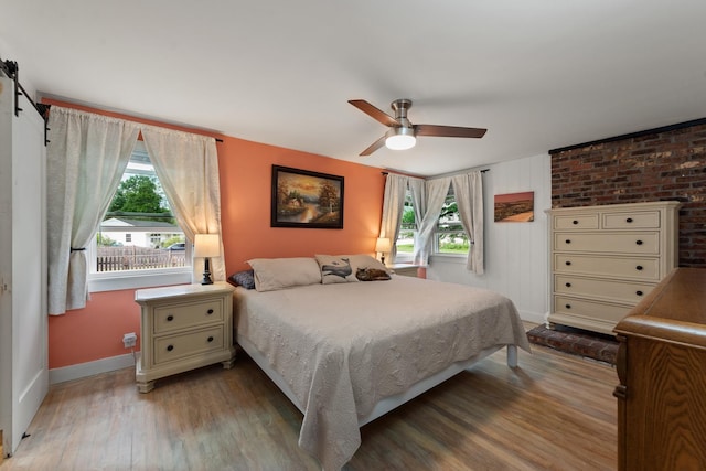 21 Redington Rd, Concord, NH 03301 - bedroom featuring multiple windows, wood finished floors, a barn door, and ceiling fan