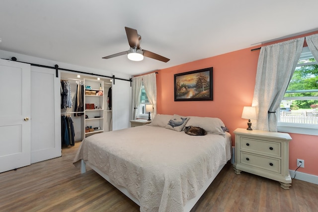 21 Redington Rd, Concord, NH 03301 - bedroom with a barn door, wood finished floors, ceiling fan, and a closet