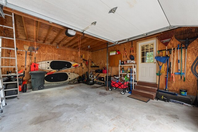 21 Redington Rd, Concord, NH 03301 - garage featuring wood walls, a garage door opener, and a workshop area