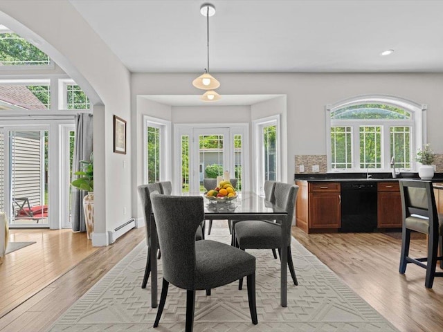 1 Dragonfly Way, Londonderry, NH 03053 - dining space with a baseboard heating unit, light wood-type flooring, recessed lighting, and arched walkways