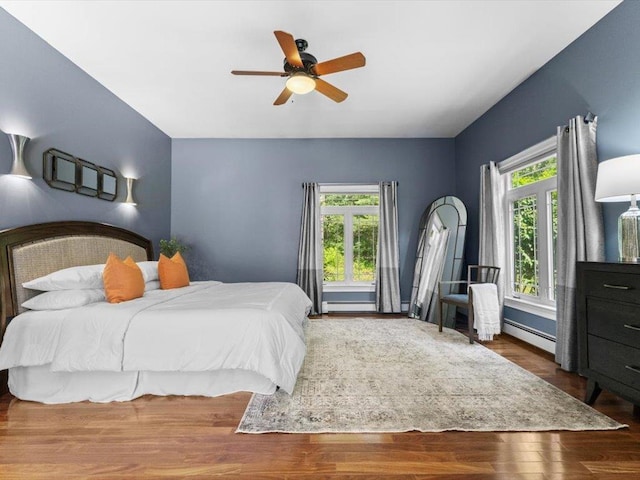 1 Dragonfly Way, Londonderry, NH 03053 - bedroom featuring a baseboard radiator, wood finished floors, and a ceiling fan