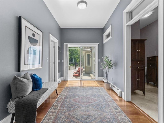 1 Dragonfly Way, Londonderry, NH 03053 - entryway featuring light wood-style floors and a baseboard radiator