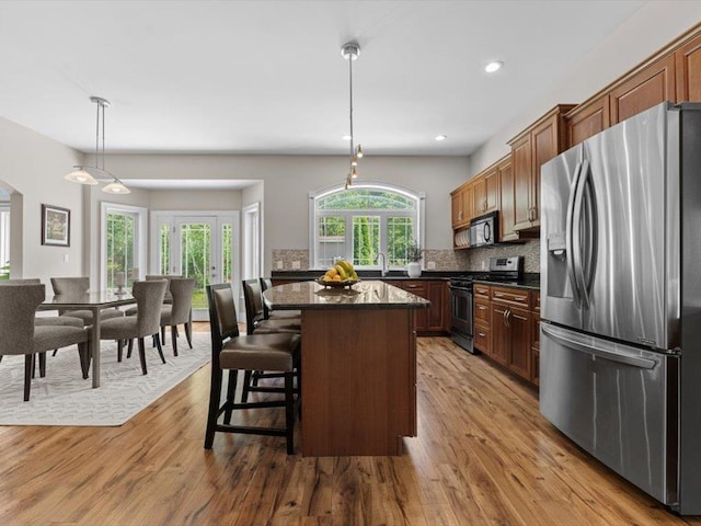 1 Dragonfly Way, Londonderry, NH 03053 - kitchen featuring stainless steel appliances, dark countertops, wood finished floors, a kitchen island, and recessed lighting