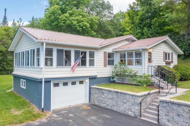 141 Manns Hill Rd, Littleton, NH 03561 - single story home with an attached garage, a metal roof, and driveway