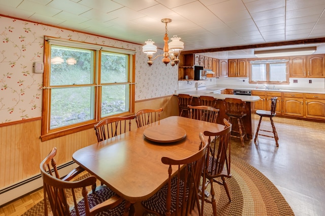 141 Manns Hill Rd, Littleton, NH 03561 - dining room featuring wainscoting, wallpapered walls, a chandelier, wooden walls, and a baseboard heating unit