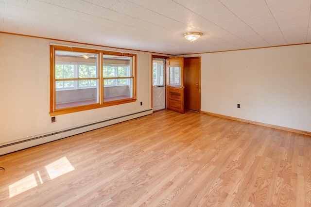 141 Manns Hill Rd, Littleton, NH 03561 - empty room with ornamental molding, a baseboard heating unit, and light wood-style floors
