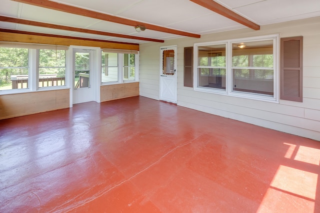 141 Manns Hill Rd, Littleton, NH 03561 - unfurnished sunroom featuring plenty of natural light, finished concrete floors, wood walls, and beam ceiling