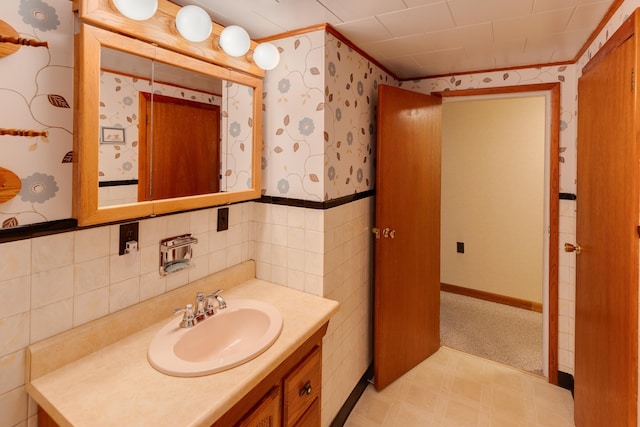 141 Manns Hill Rd, Littleton, NH 03561 - bathroom featuring tile patterned floors, wallpapered walls, vanity, and a wainscoted wall