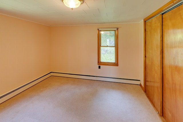 141 Manns Hill Rd, Littleton, NH 03561 - unfurnished bedroom featuring ornamental molding, a closet, light carpet, and a baseboard radiator