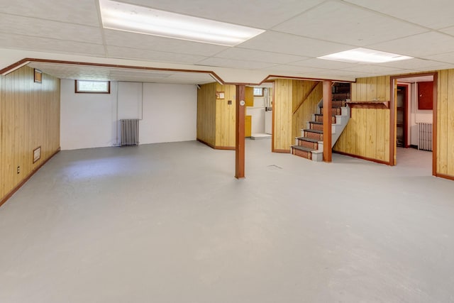 141 Manns Hill Rd, Littleton, NH 03561 - basement with radiator, wooden walls, stairway, and a drop ceiling