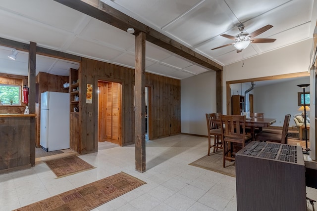 396 Mica Point Rd, Barrington, NH 03825 - basement featuring freestanding refrigerator, wooden walls, a ceiling fan, and light flooring