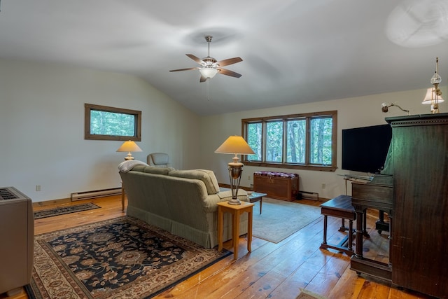396 Mica Point Rd, Barrington, NH 03825 - living room with baseboard heating, a ceiling fan, vaulted ceiling, and wood-type flooring