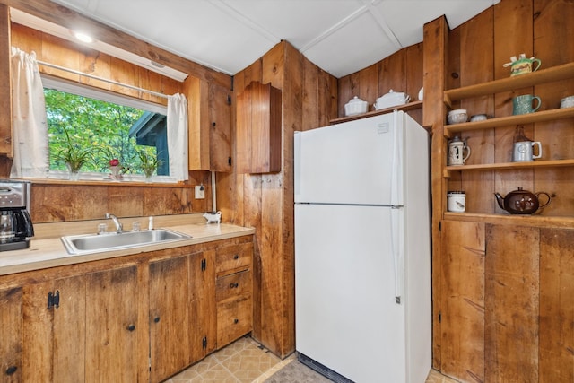 396 Mica Point Rd, Barrington, NH 03825 - kitchen with freestanding refrigerator, brown cabinets, light countertops, and wooden walls