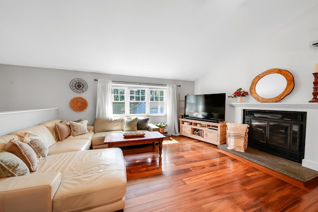20 Cimmarron Dr, Nashua, NH 03062 - living area with a glass covered fireplace, light wood-style flooring, and lofted ceiling