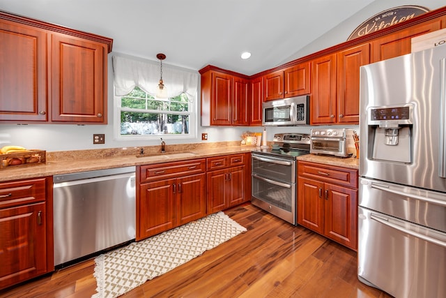 20 Cimmarron Dr, Nashua, NH 03062 - kitchen featuring stainless steel appliances, dark wood finished floors, vaulted ceiling, hanging light fixtures, and recessed lighting
