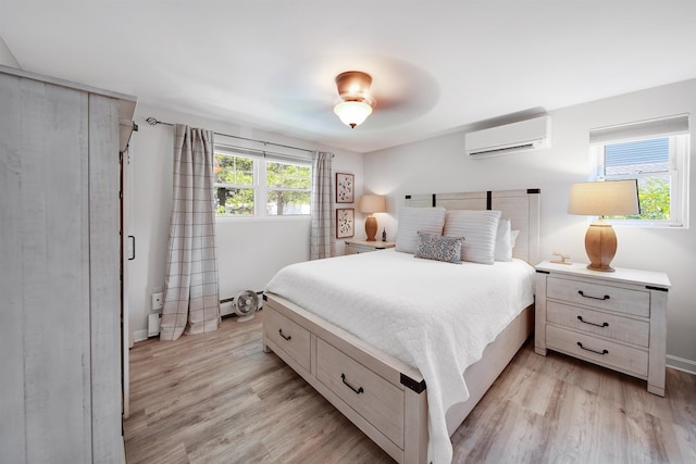 20 Cimmarron Dr, Nashua, NH 03062 - bedroom featuring a wall mounted air conditioner and light wood finished floors