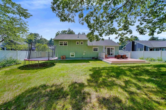 20 Cimmarron Dr, Nashua, NH 03062 - rear view of property with a trampoline, a deck, and a fenced backyard